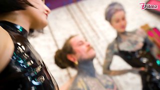 Latex Dominatrix Trio Sound & Finger the Tattooed Slave’s Cock