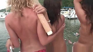 Group of drunk party girls dancing around on a boat