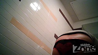 Busty MILF pissing in the toilet on the hidden camera