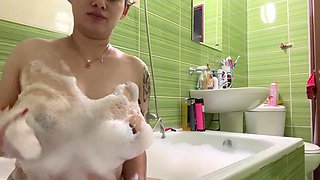 Pregnant beauty captivates with sultry, massive bath allure