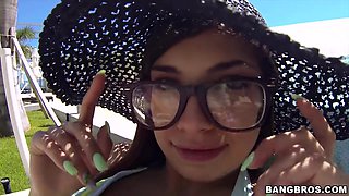 Cute girl in glasses by the pool picked up