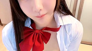 Asian schoolgirl in uniform brings her pussy to orgasm